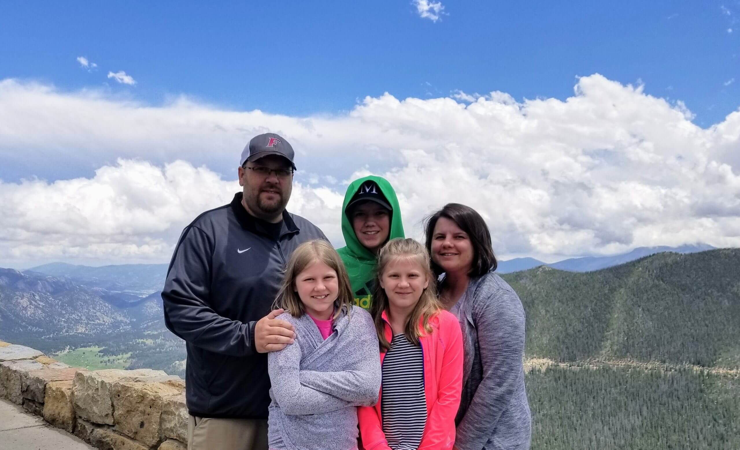 Matt Moore with family in front of mountains