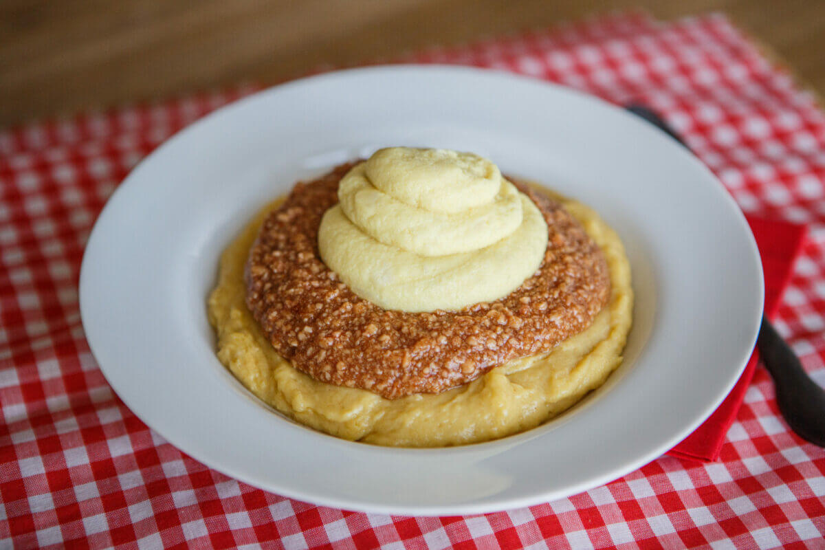 Dysphagia-friendly bbq sundae with mashed potatoes, pulled pork and bread on a white plate