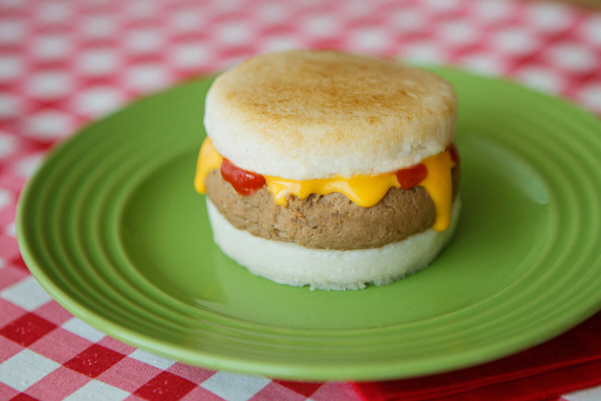 Dysphagia-friendly cheeseburger on green plate