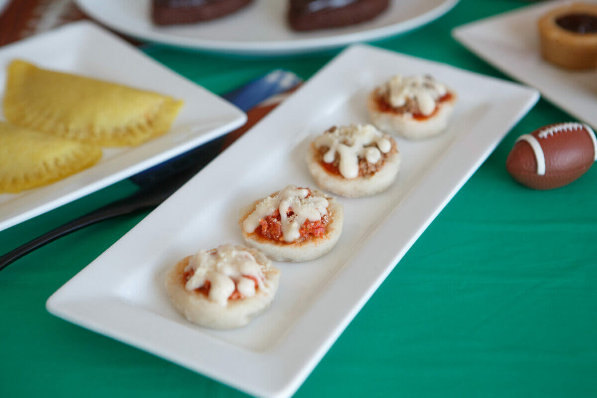 Dysphagia-friendly pizza bites on white plate with mini footballs