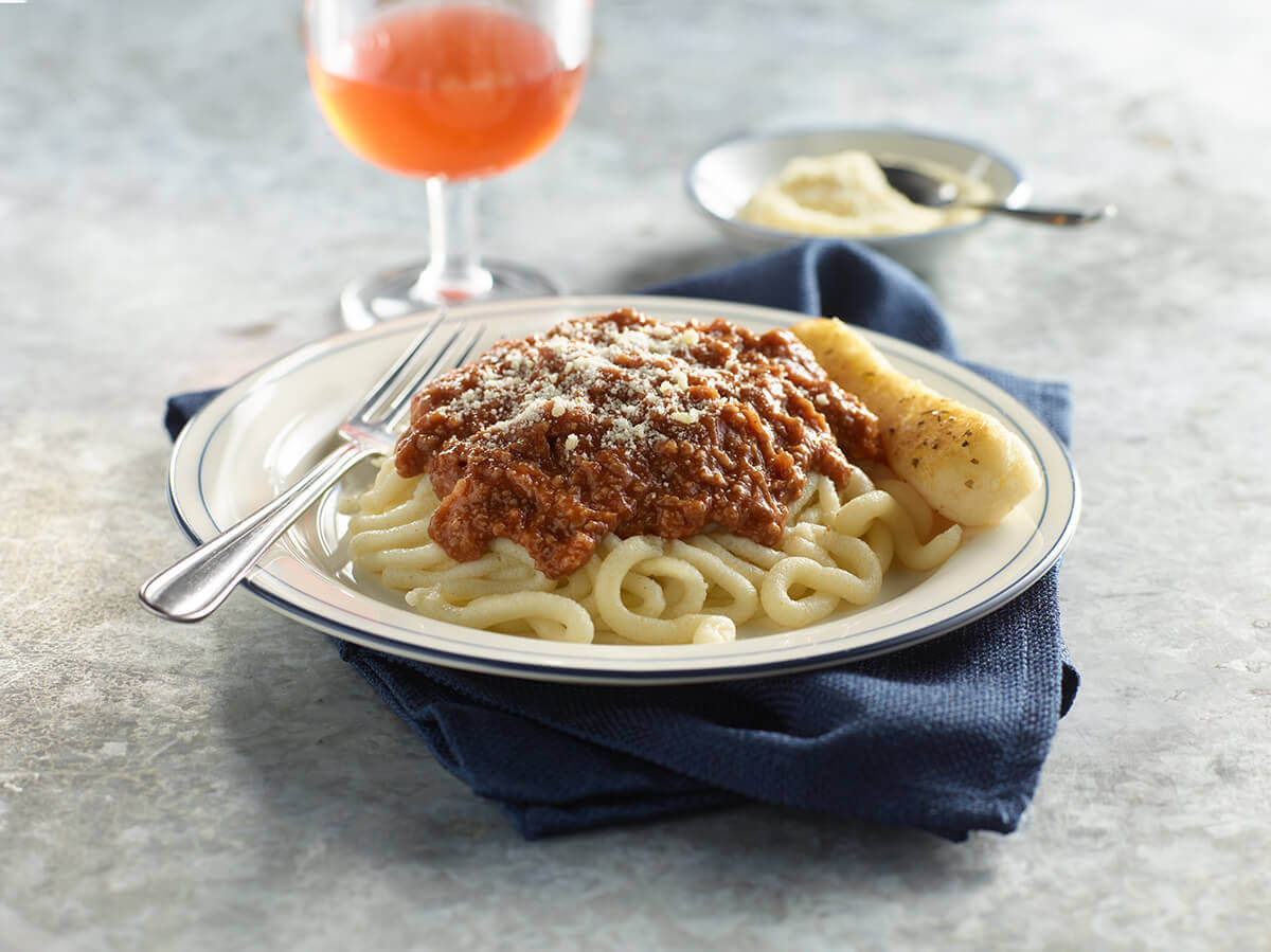 IDDSI Level 5 Pasta with beef marinara and a breadstick