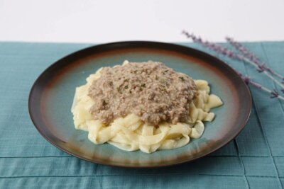Beef stroganoff for dysphagia diets on blue plate