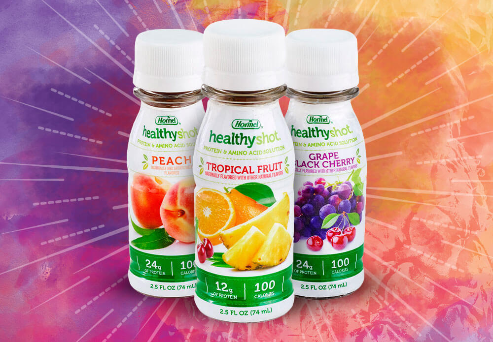 Three healthyshot high protein bottles overtop a color background