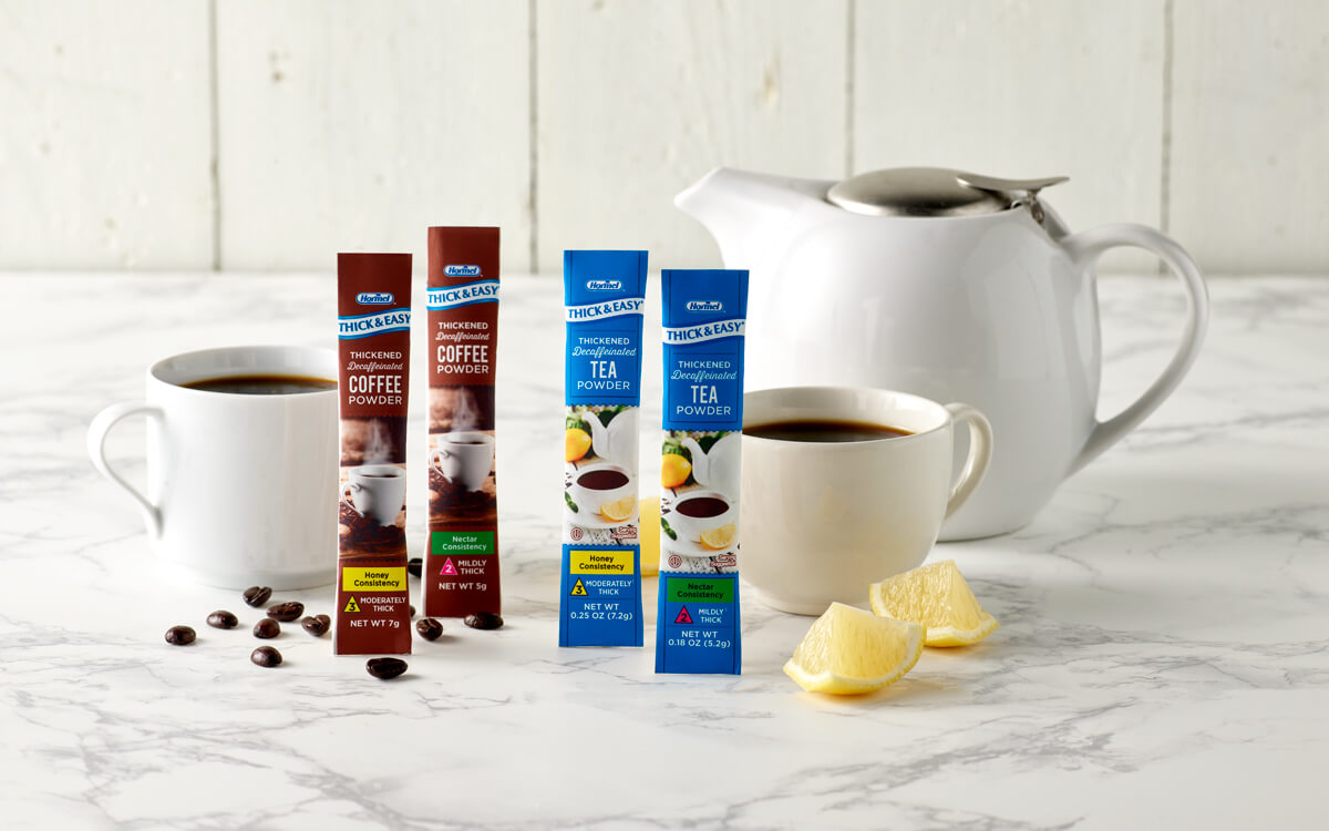 Hormel Health Labs Coffee and Tea Sticks in front of mugs