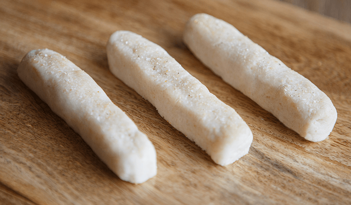 IDDSI Level 4 garlic breadsticks on a butcher's block