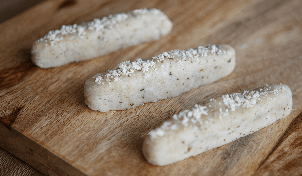 Level 4 herb pamesan breadsticks served on a butcher's block