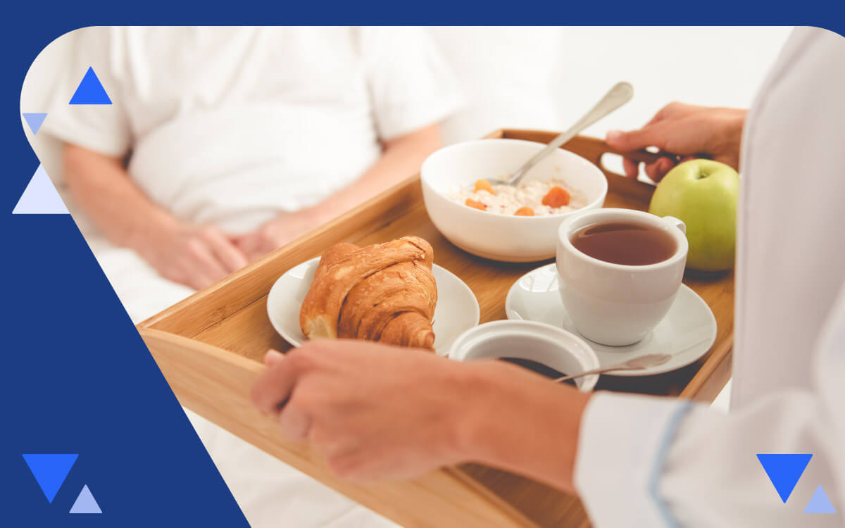 Caregiver holding tray with food for patient