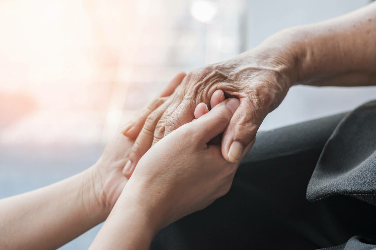 Doctor holding a senior patient's hands